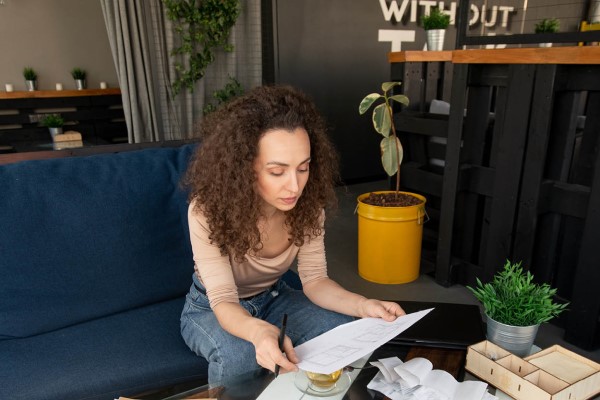 Curly Haired Woman Looking At Report